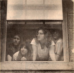 Students staging a 150-hour protest peer from their stronghold in an administrative office.